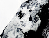 Kolaps šelfového ledovce v Antarktidě. Fotografie družice Aqua z 21. března 2022. Proces rozpadu byl velmi rychlý a proběhl během pouhých dvou týdnů. Mizející šelfové ledovce mohou urychlit tání pevninského ledu, protože fungují jako brzda bránící rychlému toku ledu z kontinentu. Přestože v tomto konkrétním případě je ohrožená oblast minimální, faktem je, že kolaps šelfového ledovce ve východní části Antarktidy byl zaznamenán poprvé a podle vědců signalizuje zvyšující se riziko destabilizace a rychlejšího tání v prostoru Východoantarktického ledového příkrovu.